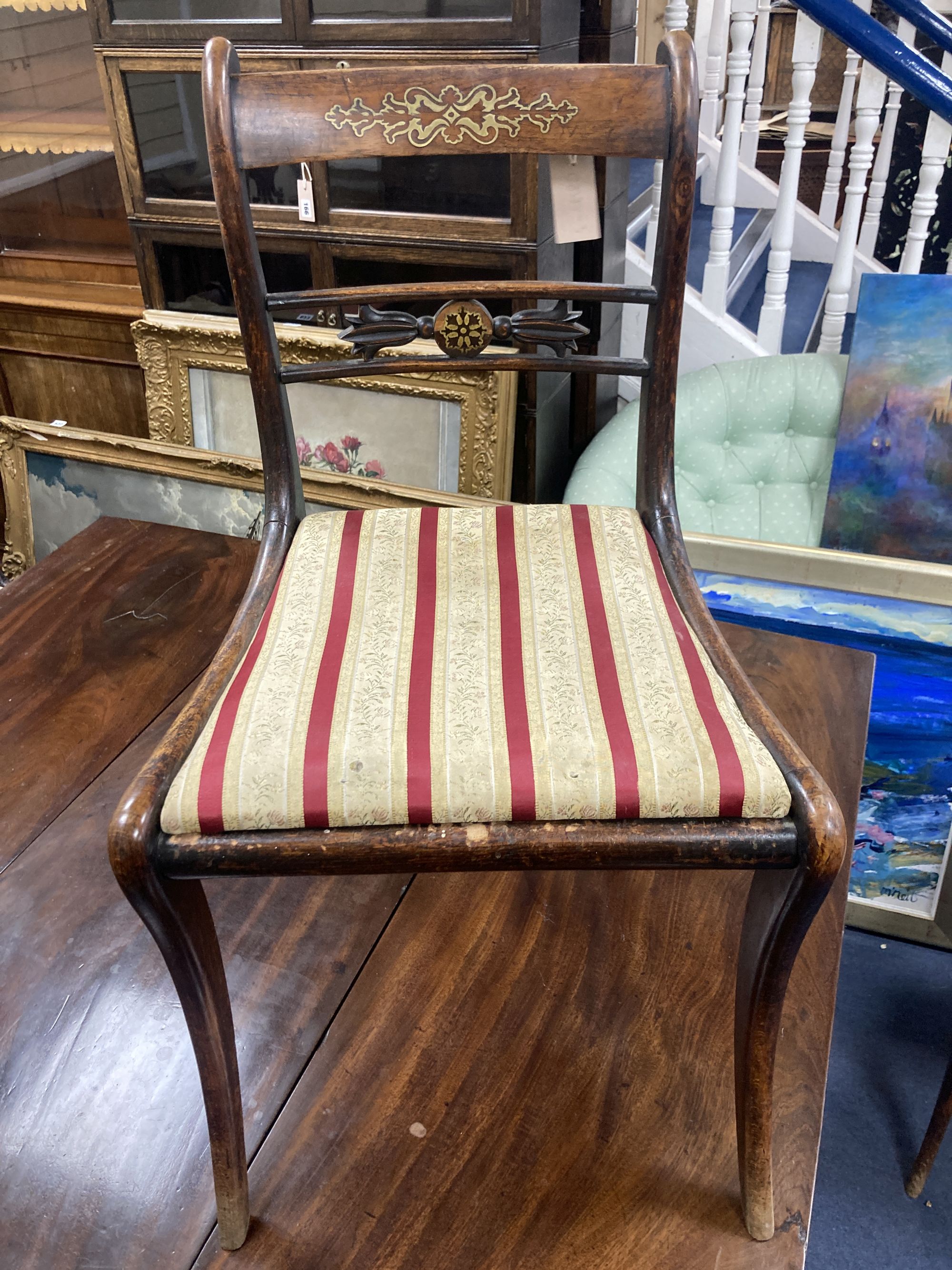 A set of five Regency brass inlaid simulated rosewood cane seated dining chairs